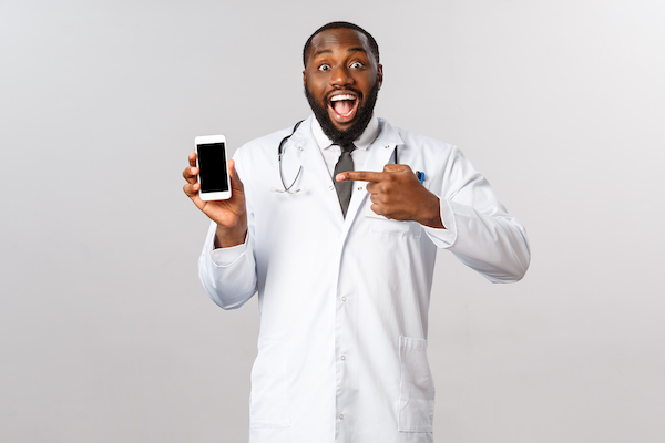 man holding and pointing to phone excitedly