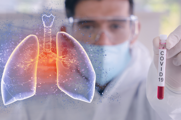 man holding vial while looking at lung diagram